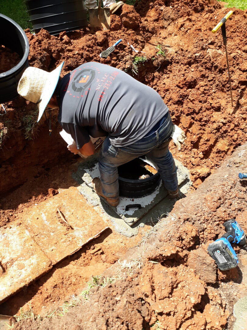 Professional technician performing septic tank repair in Smithfield, NC.