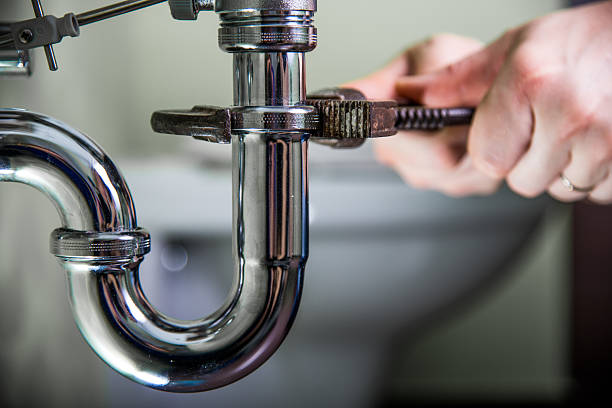 Plumber doing repair work on a drain.