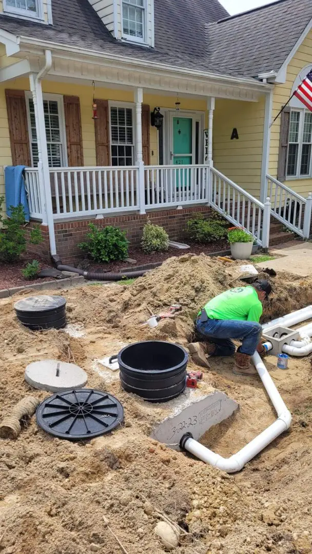 a man in green t shirt is working on the pipes