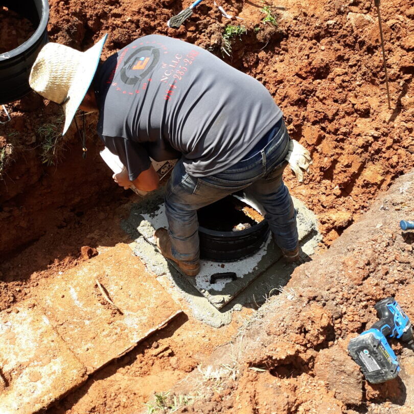 Professional technician performing septic tank repair in Smithfield, NC.
